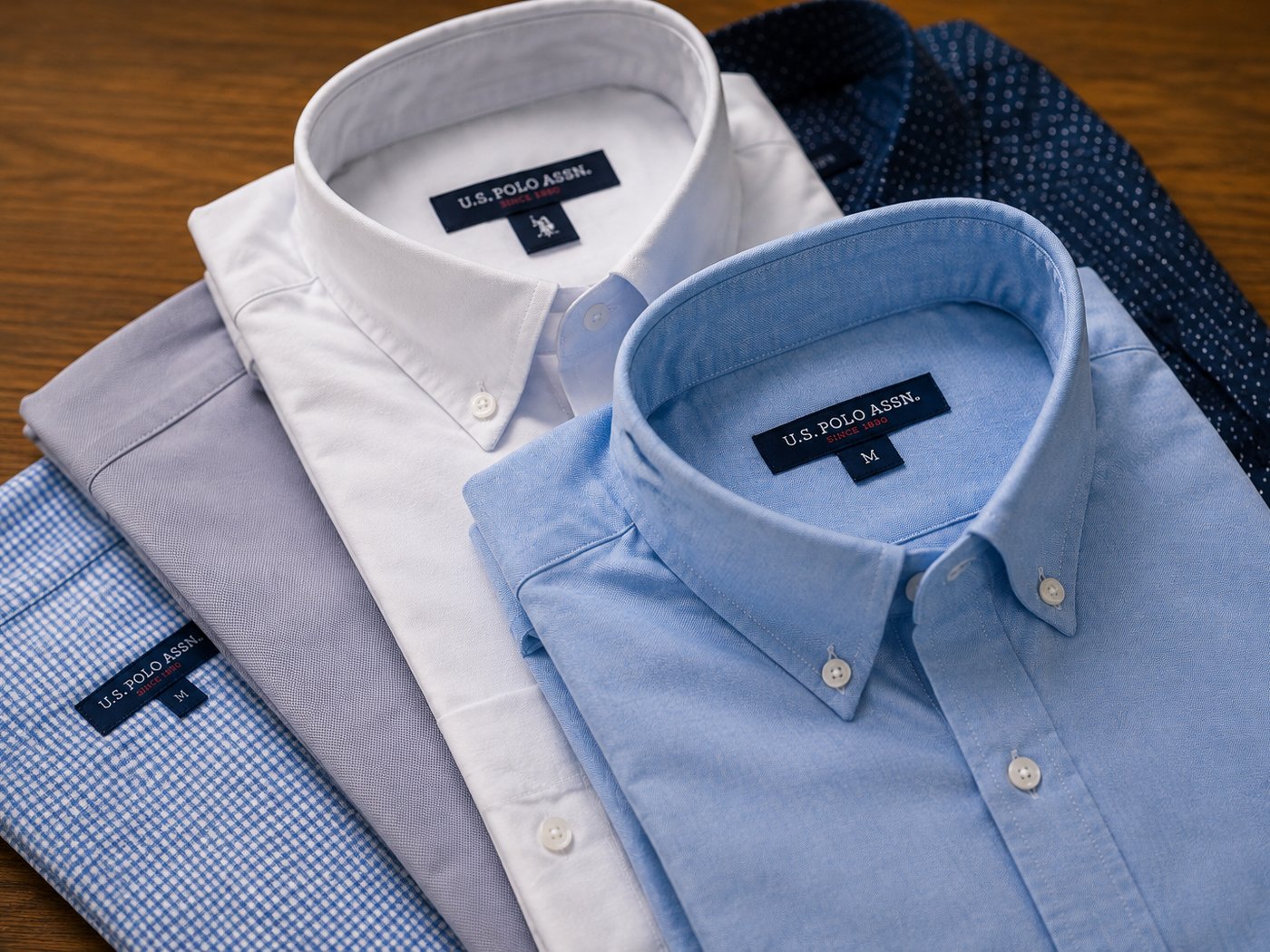 Folded men's oxford and check shirts at Arime Company in Baghdad